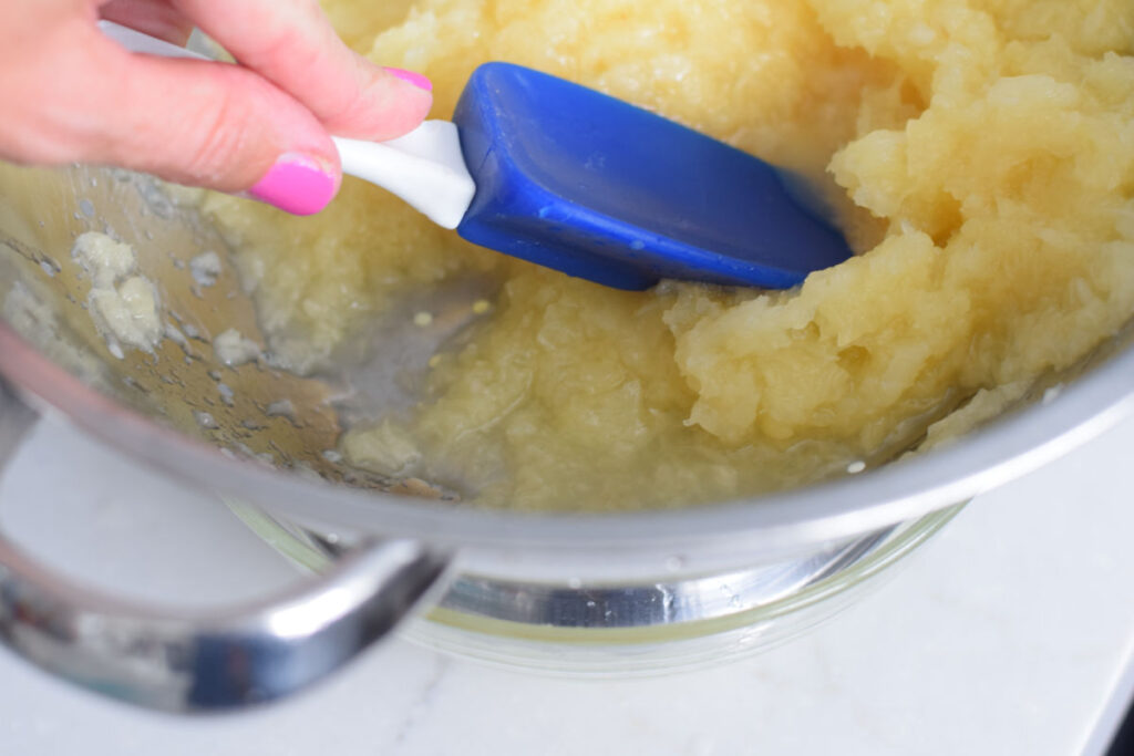 straining pineapple for blueberry bread 